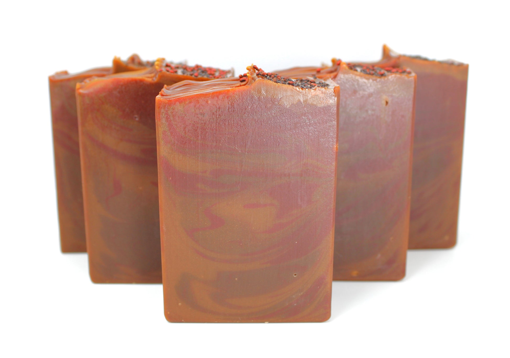 Brown and red swirled soap staggered on a white background.