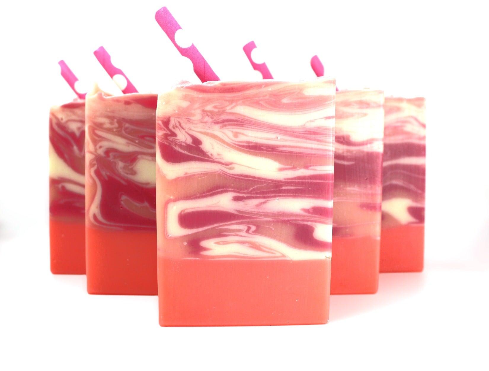 5 bars of Pink, White, and Orange bar soap with swirls and a pink paper straw on a white background.