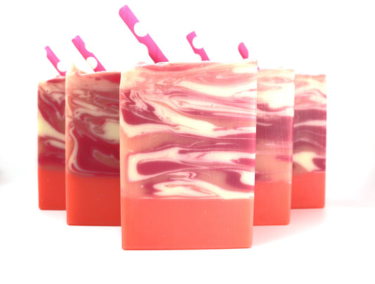 5 bars of Pink, White, and Orange bar soap with swirls and a pink paper straw on a white background.
