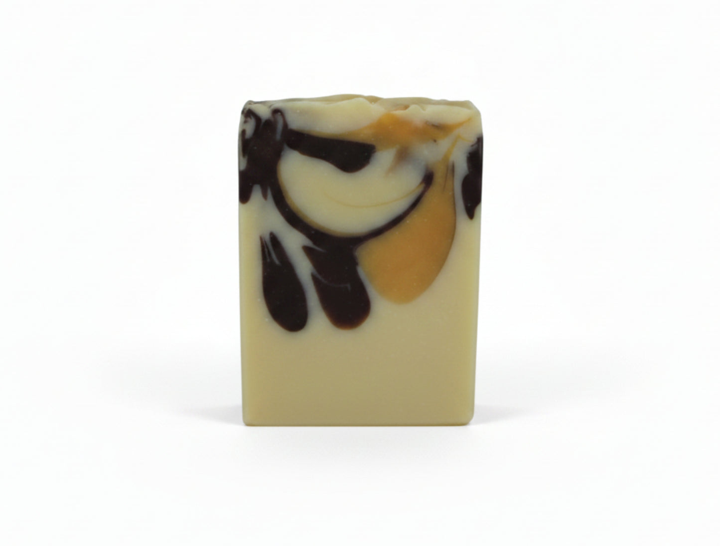 A single rectangular bar of handmade soap with a marbled swirl pattern of cream, dark brown, and yellow, standing upright against a plain white background.