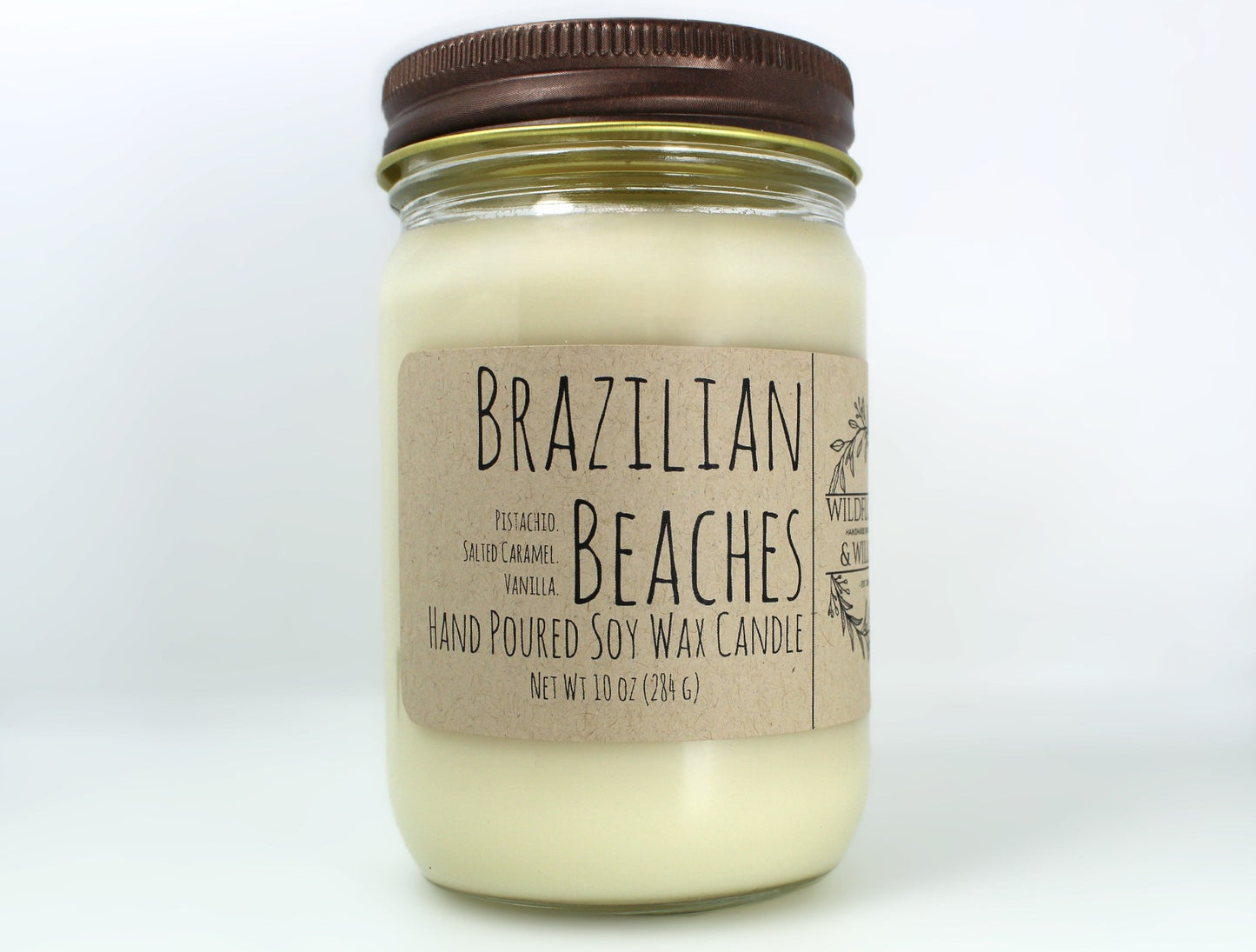 White wax candle in a mason jar with a rustic brown metal lid. Kraft brown label with black text. White background.