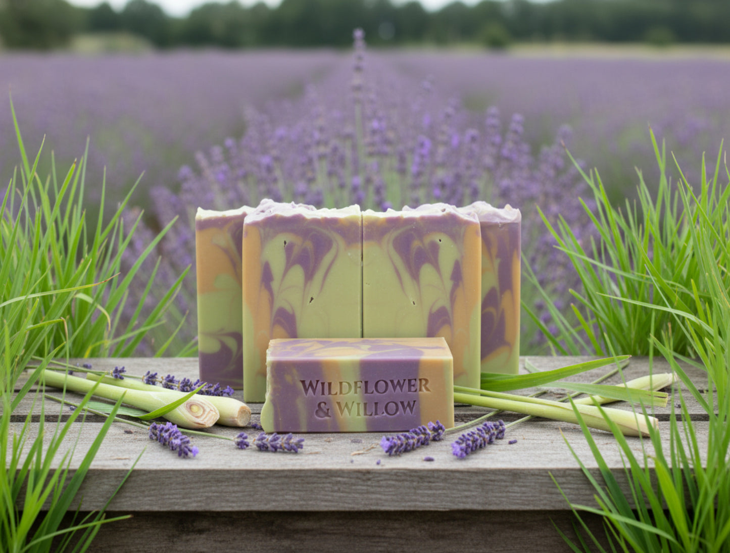 Bars of soap with a marbled pattern and 'Wildflower & Willow' branding in a field of lavender