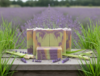 Bars of soap with a marbled pattern and 'Wildflower & Willow' branding in a field of lavender