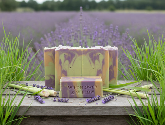 Bars of soap with a marbled pattern and 'Wildflower & Willow' branding in a field of lavender