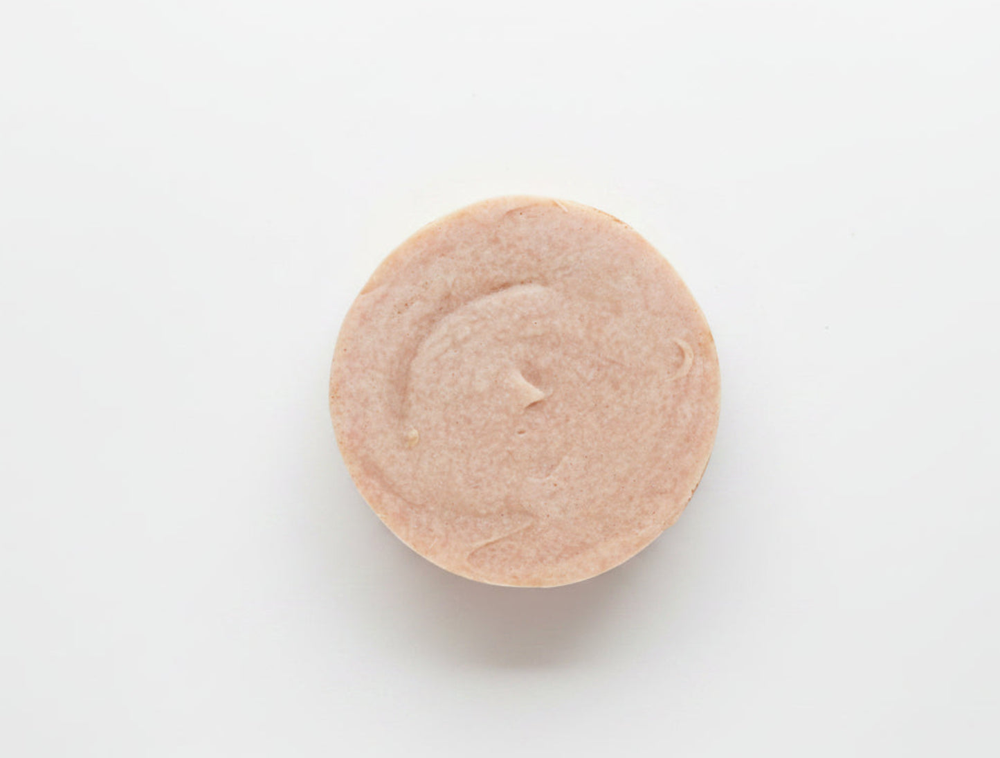 Round orange soap on a white background