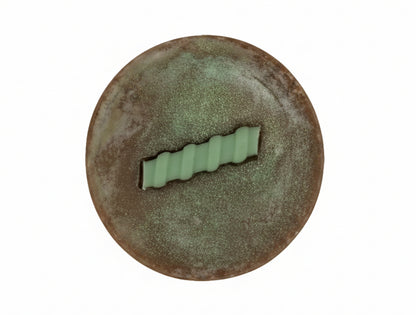 round brown bar of soap on a white background