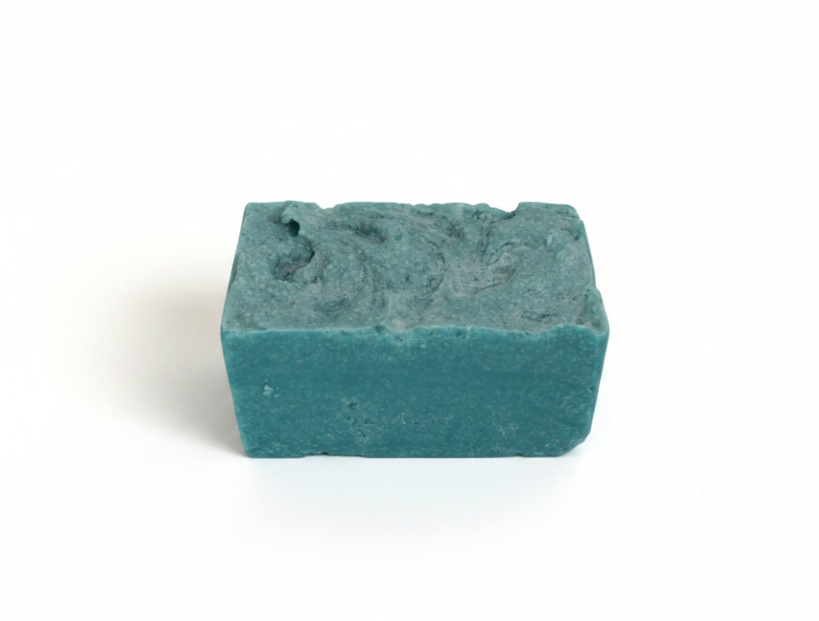 Blue-green bar of soap on a white background