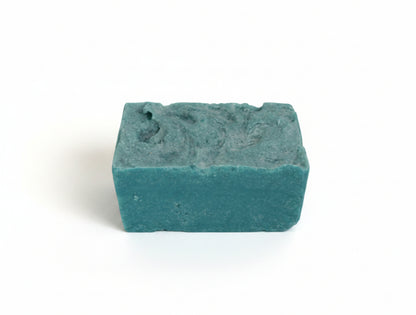 Blue-green bar of soap on a white background